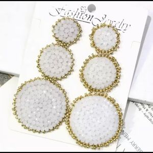 Beaded white and gold dangle earrings.